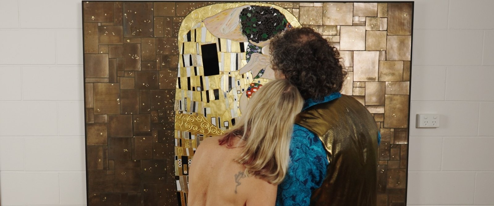 Brett and Kari looking at The Kissing Project mosaic