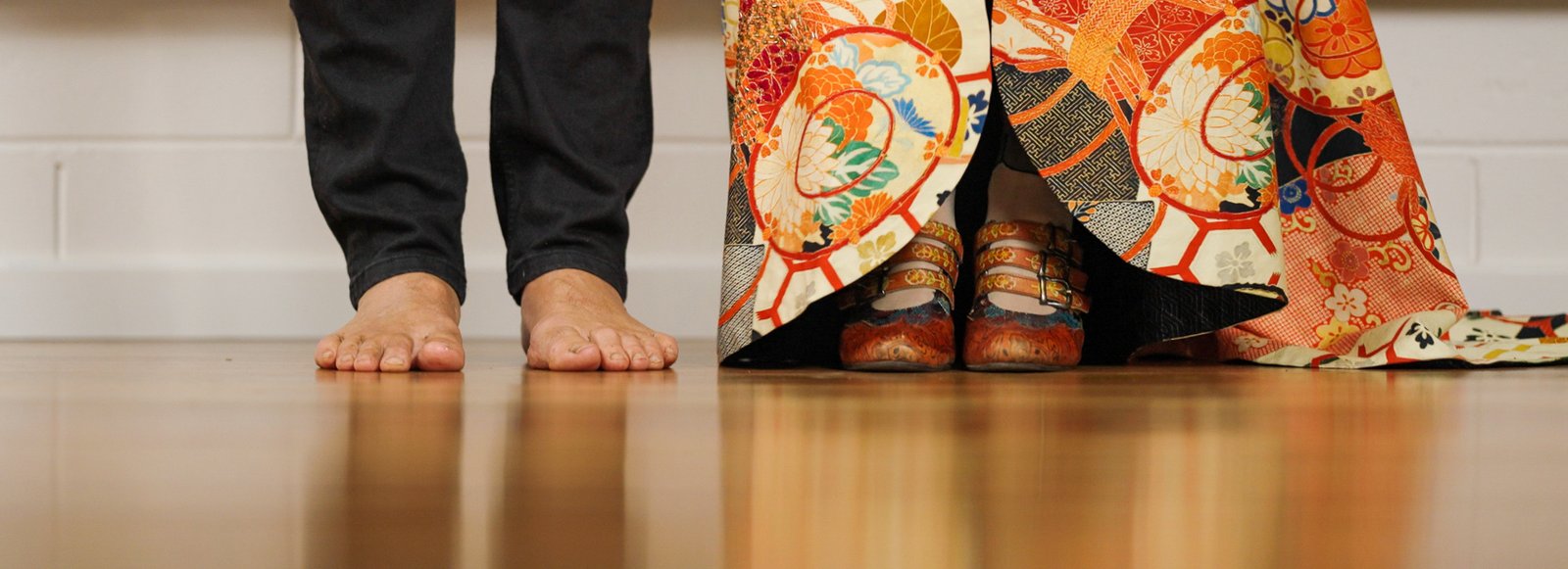 Brett barefoot beside Kari's shoes